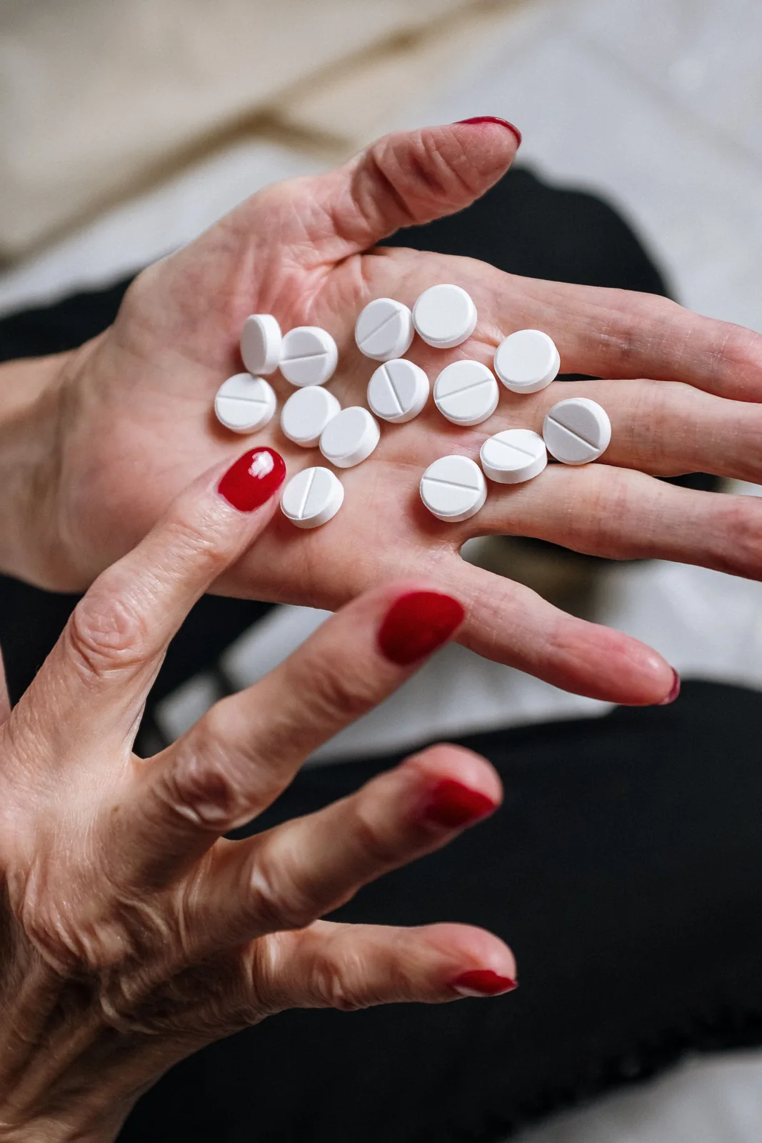 A handful of daily tablets held in an open hand