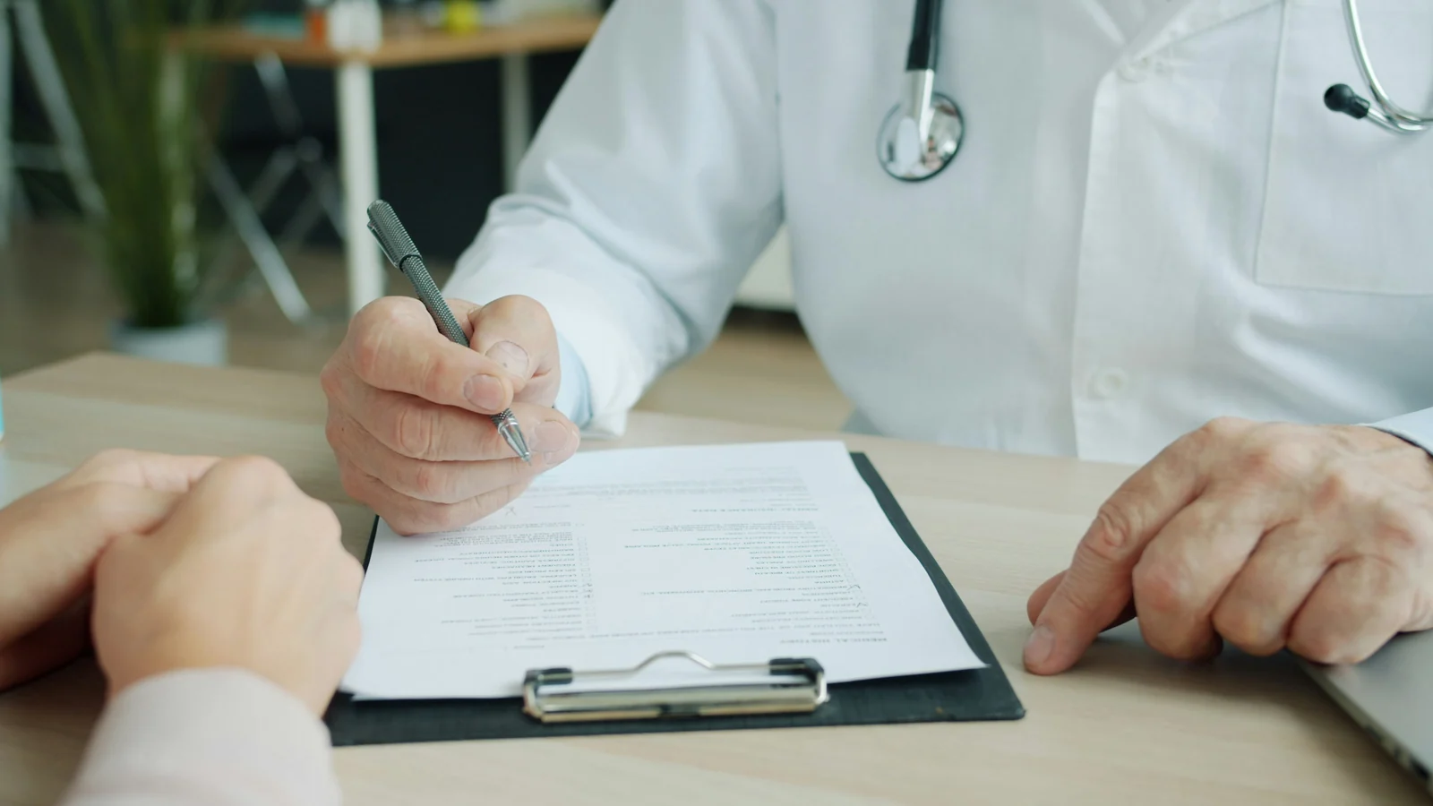 A clinician going through an intake form with a patient