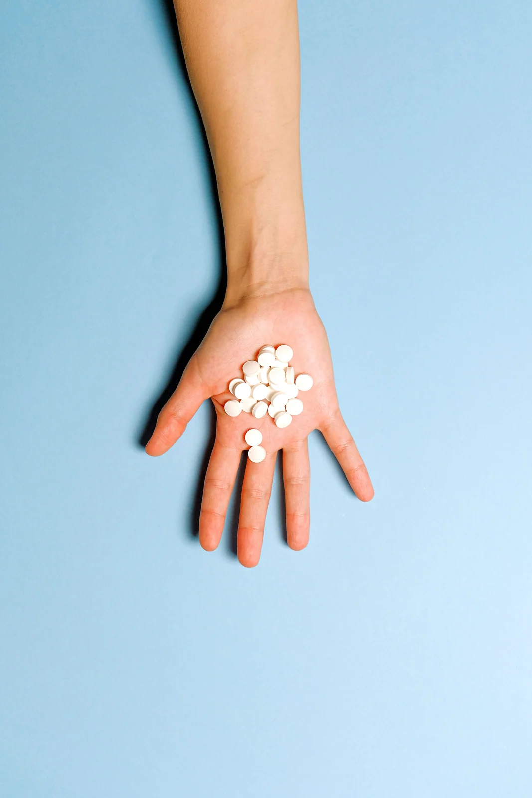 A single dose held in the palm of a hand