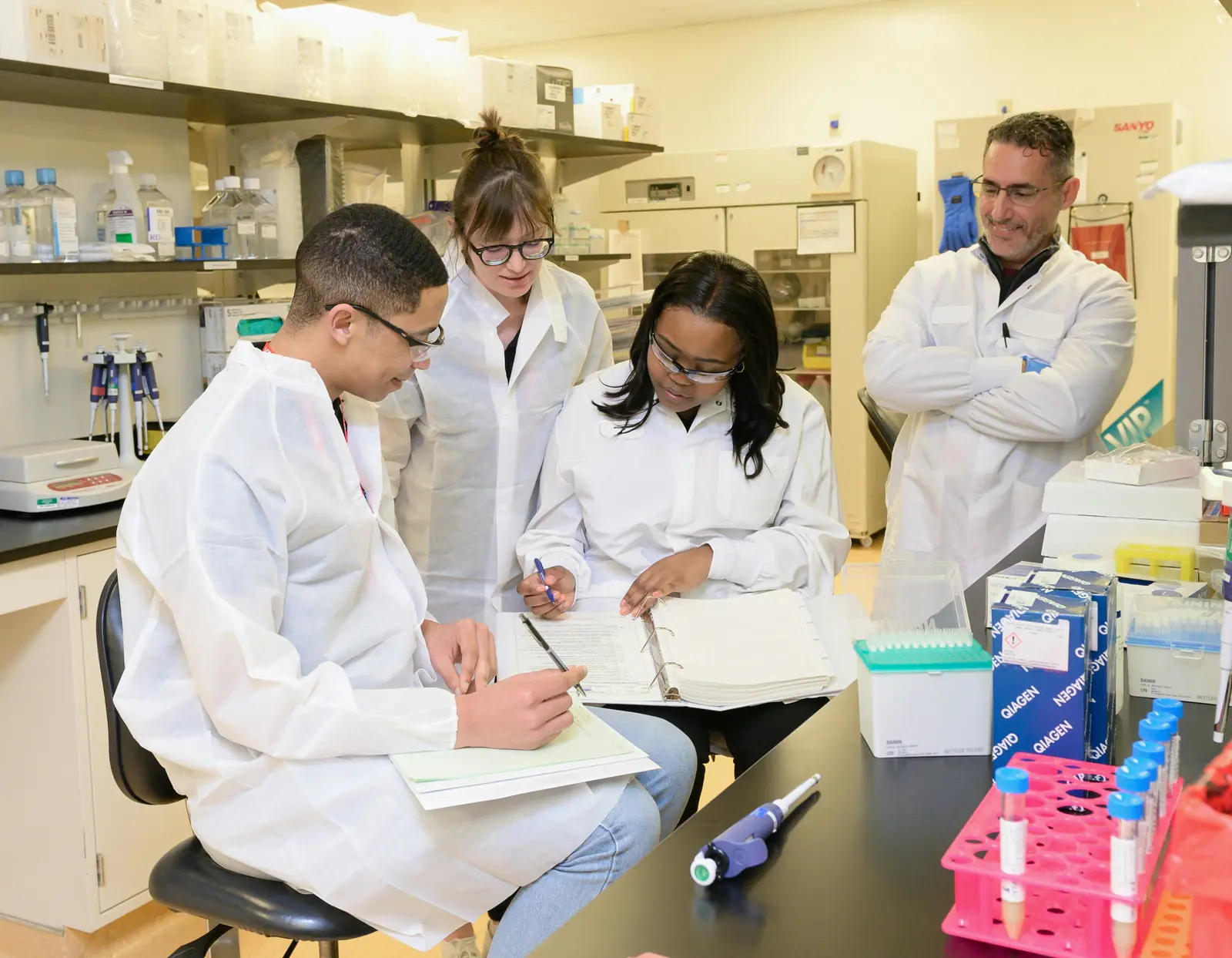 A laboratory team going over a file