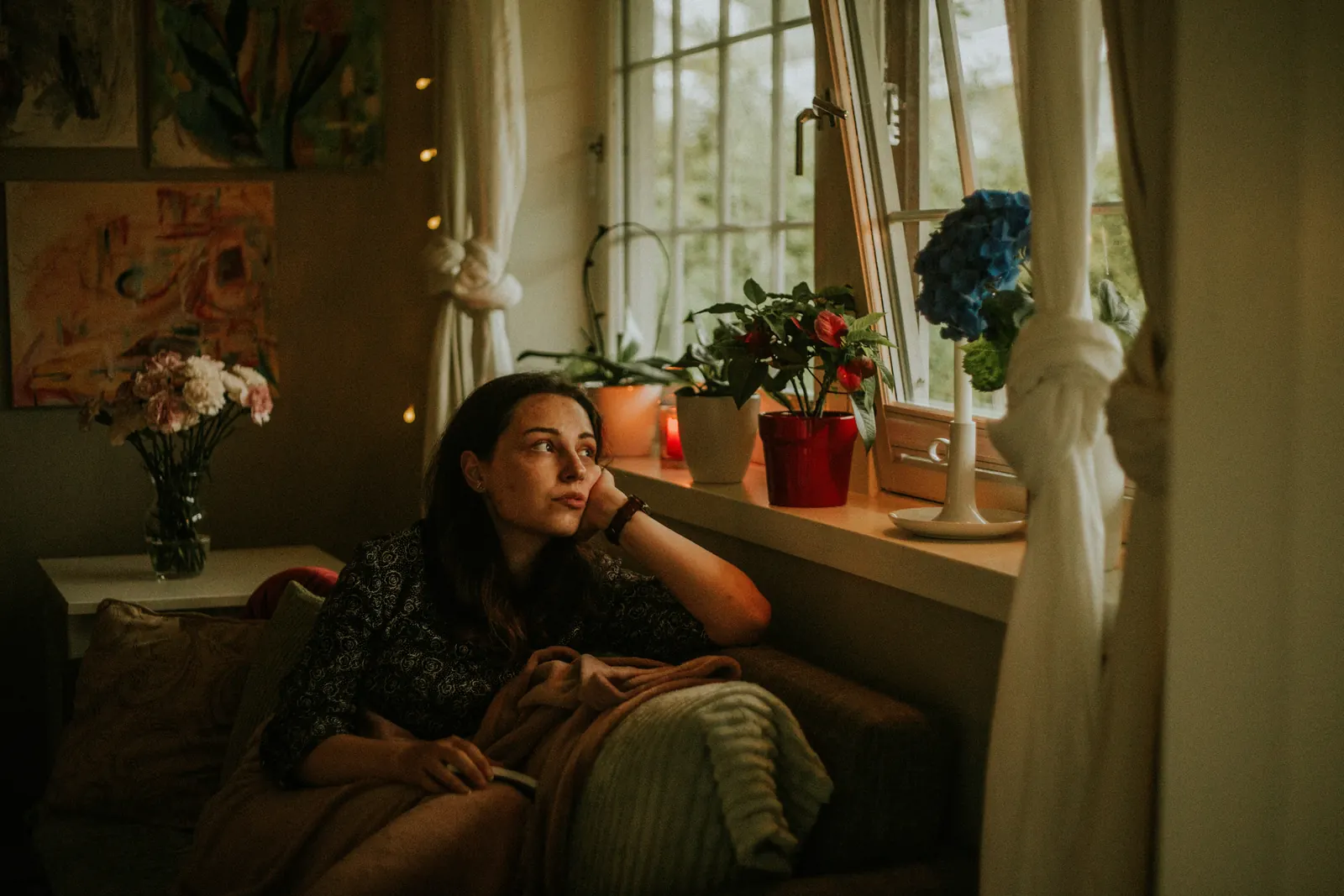 A woman resting on a sofa during a difficult patch of symptoms