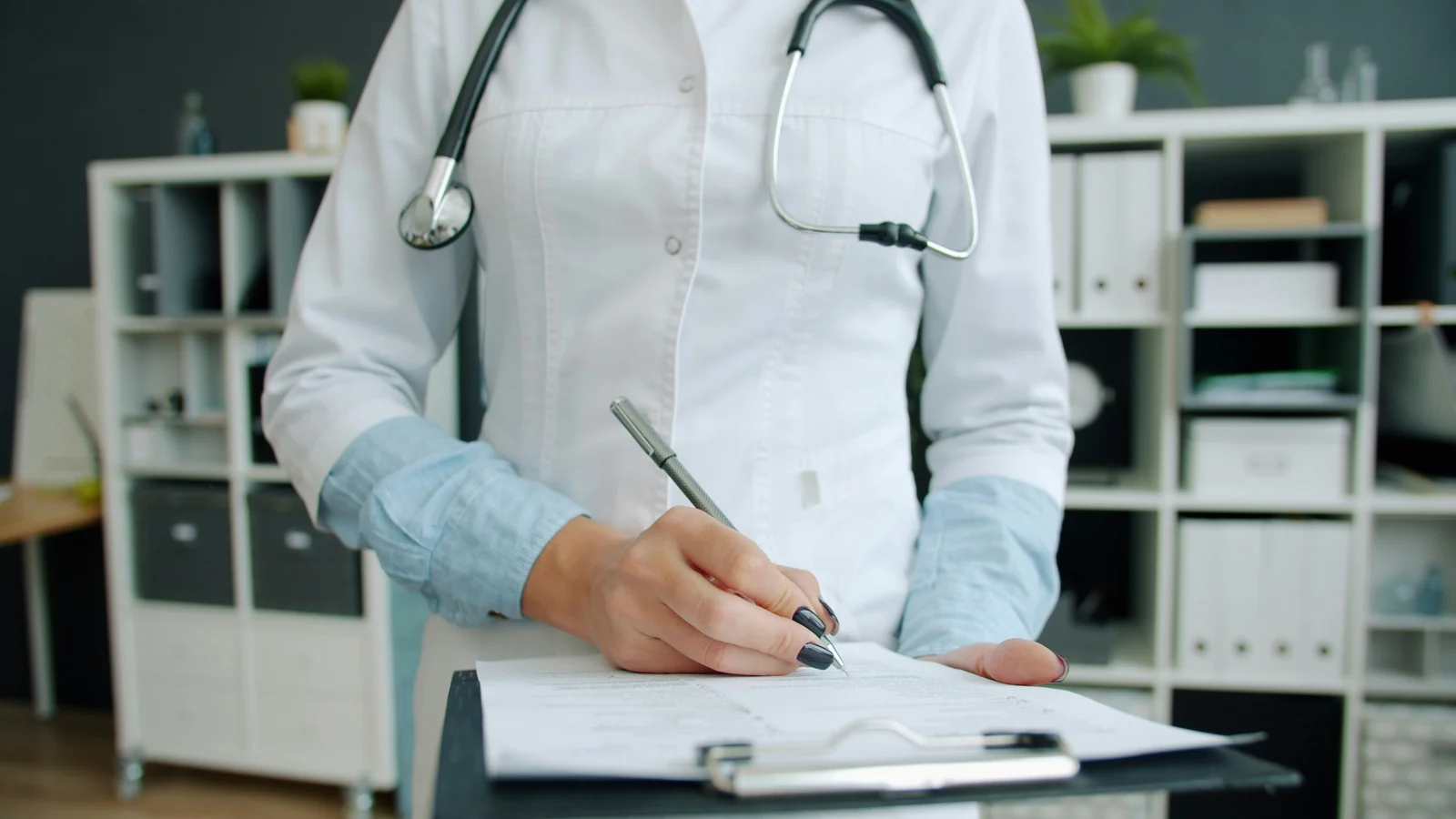 A clinician writing up visit notes